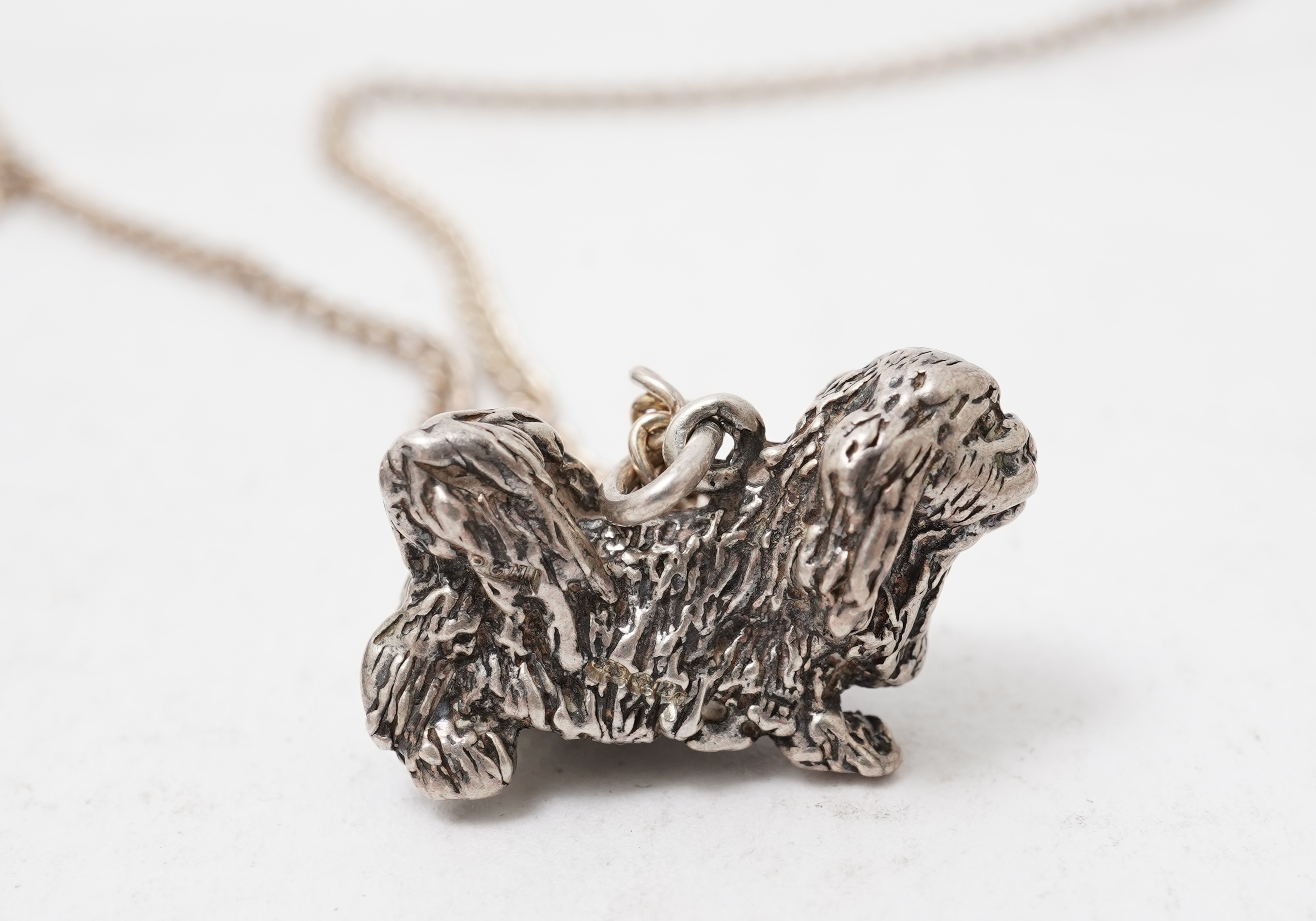 A collection of jewels including an Art Deco silver cigarette case